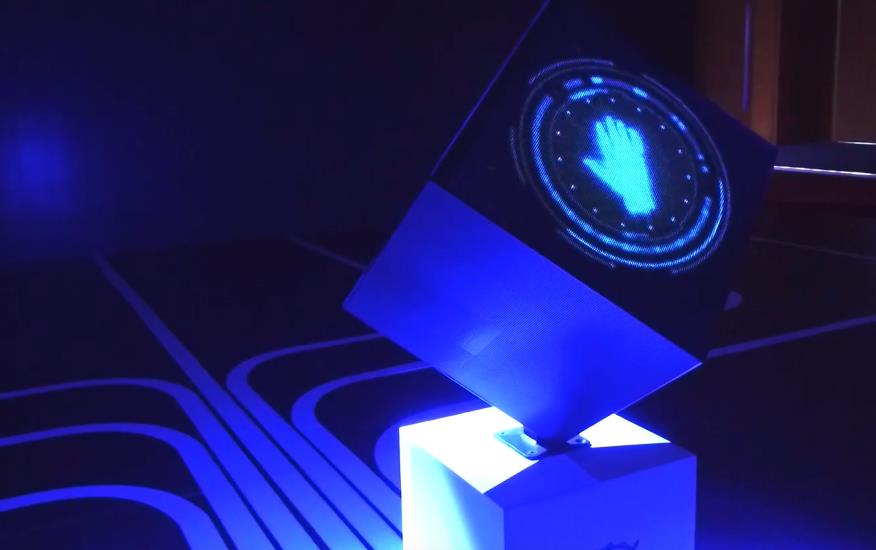 A glowing LED cube and illuminated podium for an event launch.