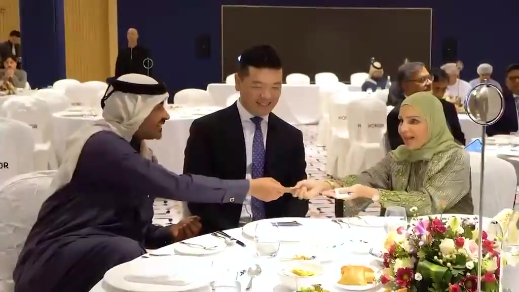 Guests conversing at a dressed banquet table at the HONOR gathering