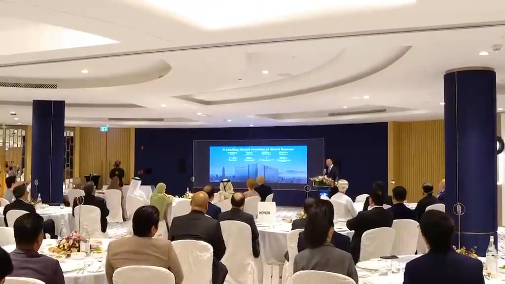 Guests seated around banquet tables facing a presentation screen at a HONOR gathering