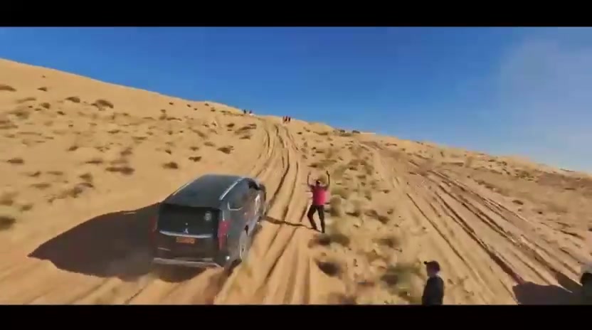Mitsubishi Montero vehicles and guests during a desert drive.