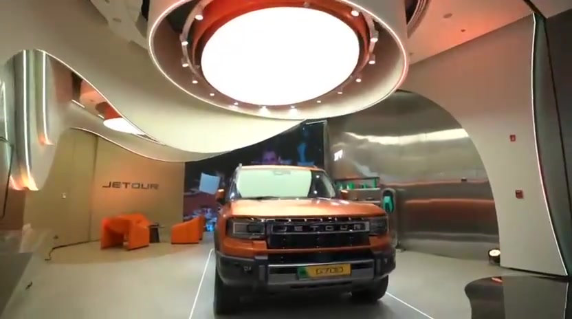 A Jetour vehicle display beneath a circular architectural light feature.